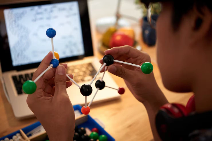 Student building a molecular model for a Science Olympiad Foundation project.